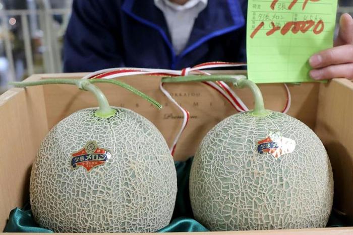 A pair of premium Japanese melons have sold for just a slice of the five million yen ($46,000) reached at auction last year