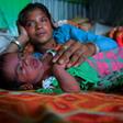 Manju Bauri rests with her newborn baby boy 'Lockdown' in their temporary home in northeast India