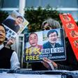 Hong Kong pro-democracy activists attend a protest in support of jailed Chinese human rights lawyer Wang Quanzhang (R on placard) and China's first "cyber-dissident" and founder of human rights website "64 Tianwang", Huang Qi (L on placard)