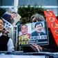Hong Kong pro-democracy activists attend a protest in support of jailed Chinese human rights lawyer Wang Quanzhang (R on placard) and China's first "cyber-dissident" and founder of human rights website "64 Tianwang", Huang Qi (L on placard)