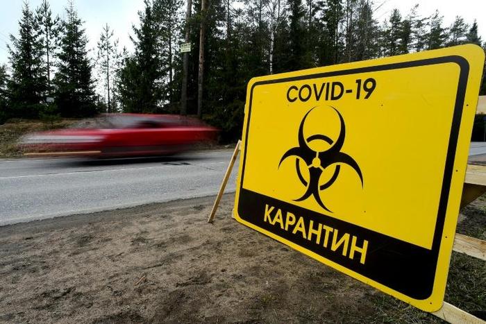 A sign reads "Quarantine COVID-19" outside the village of Pervomaiskoye near Saint Petersburg