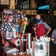 Patrons, some wearing masks and some not, sit at a bar in Austin, Texas, on June 26, 2020, as Governor Greg Abbott said he had allowed bars to reopen too soon