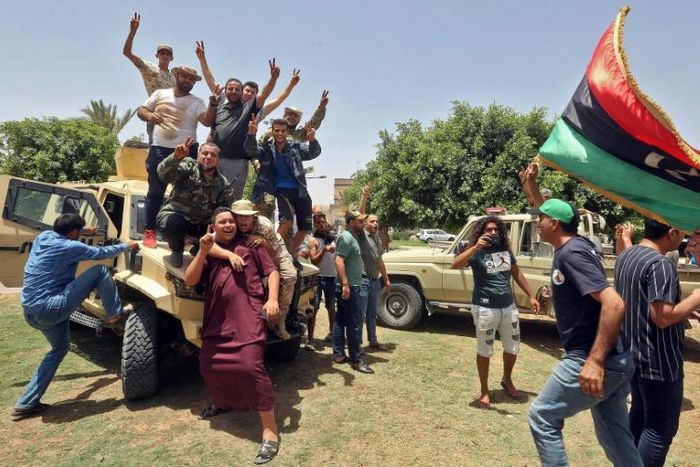 Fighters loyal to Libya's UN-recognised Government of National Accord celebrate after seizing the town of Tarhuna from forces of strongman Khalifa Haftar on June 5, 2020