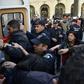 Algerian police detain protesters after a demonstration in the capital Algiers on April 14, 2019
