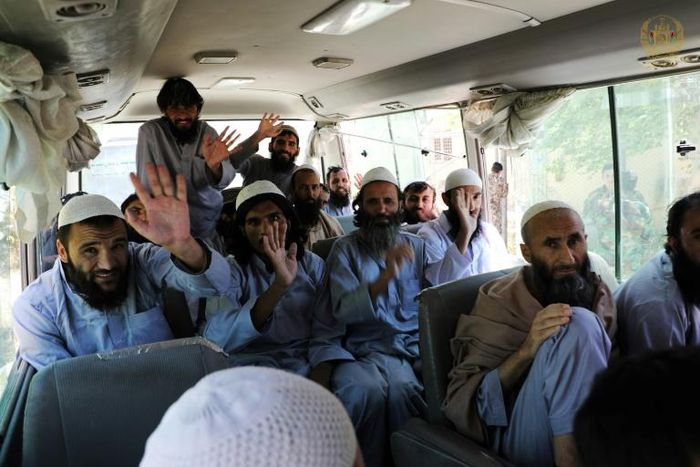 Taliban fighters wave on a bus after being released from prison in Bagram in a handout photograph released Afghanistan's National Security Council