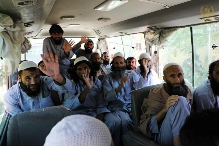 Taliban fighters wave on a bus after being released from prison in Bagram in a handout photograph released Afghanistan's National Security Council