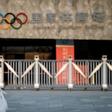 Passers-by at Beijing's Olympic Park wear protective face masks as the coronavirus pandemic causes problems around the world