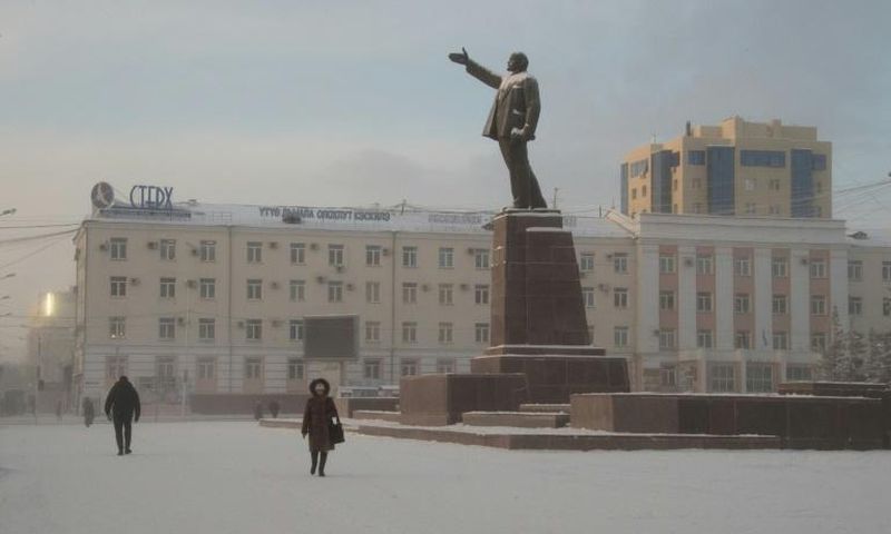 Locals walk through a square in the Siberian city of Yakutsk, where a court ruled to commit a shaman critical of Vladimir Putin to a mental asylum