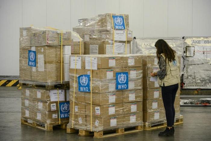 A staff member checks boxes of personal protective equipment aimed at helping the World Health Organization fight the coronavirus, at Ethiopia Airlines' cargo facility at the Bole International Airport in Addis Ababa