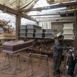 A worker prepares to paint a coffin at a factory in Lima's  Juan de Lurigancho district