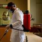 A cleaner disinfects the display case housing the gold funeral mask of famed pharaoh Tutankhamun at the Egyptian Museum in Cairo