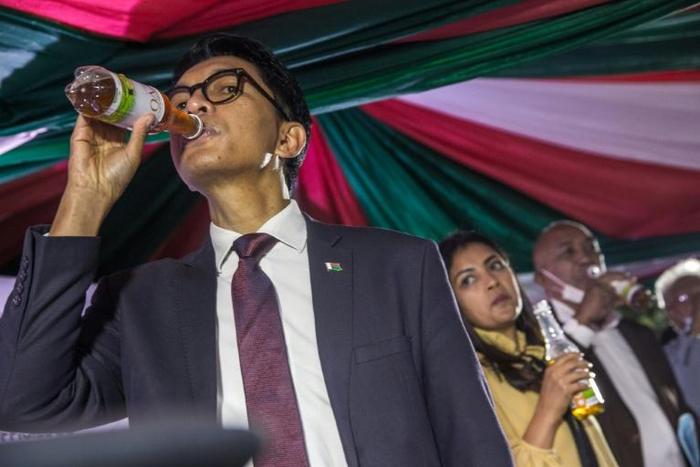 Madagascar's President Andry Rajoelina sips Covid Organics, which he touts as a remedy for coronavirus