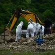 Honduran workers bury a COVID-19 victim. Infections have surged in Latin America and the Caribbean, which now have 2,007,621 confirmed cases