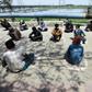 Homeless Indians sit in "isolation circles" outside a shelter while waiting for food in New Delhi