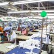 Workers sew personal protective equipment in Ghana, which has lifted a coronavirus lockdown that hit the poor hard