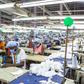 Workers sew personal protective equipment in Ghana, which has lifted a coronavirus lockdown that hit the poor hard