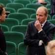 Fianna Fail leader Micheal Martin (R) talks with the man who he has replaced as Irish prime minister, Leo Varadkar after the vote at a special sitting of the Dail parliament