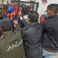 Tunisians angered by a coronavirus lockdown gather outside a government office on the outskirts of the capital