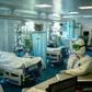 Medical workers wearing protective equipment treat patients infected with COVID-19 in Moscow's K+31 private hospital
