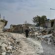A man walks in al-Mastuma, about seven kilometres south of Idlib city in northwest Syria, on March 10