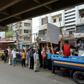 People queue to collect subsidised food in Dhaka