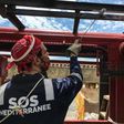 A crew member of French NGO SOS Mediterranee rescue boat Ocean Viking paints parts of the boat moored in the port of Marseille, on the eve of a scheduled departure for a migrants search and rescue mission off the coast of Libya