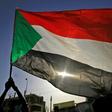 The Sudanese flag flies in Khartoum during a commemoration of a deadly raid a year ago on an anti-government sit-in