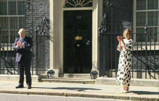 British Prime minister Boris Johnson and 'Clap for Carers' founder Annemarie Plas clap for the NHS outside 10 Downing street