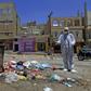 A Yemeni volunteer sprays disinfectant in a poor district of the capital Sanaa amid fears of a coronavirus outbreak