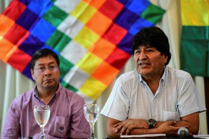 Former Bolivia president Evo Morales (right) sits alongside the presidential candidate for his Movement for Socialism party, Luis Arce