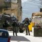 Israeli soldiers hunt for the Palestinian stonethrower believed to be responsible for the death of a comrade during an arrest operation in the village of Yaabad in the occupied West Bank