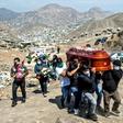 Relatives carry the coffin of a suspected COVID-19 victim at the Nueva Esperanza cemetery, one of the largest in Latin America, in the southern outskirts of Lima -- Peru has lost at least 170 police officers to the disease