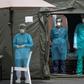 Medical staff at Mohammmed V military hospital wear  protective masks and caps as they wait for patients in the Moroccan capital Rabat