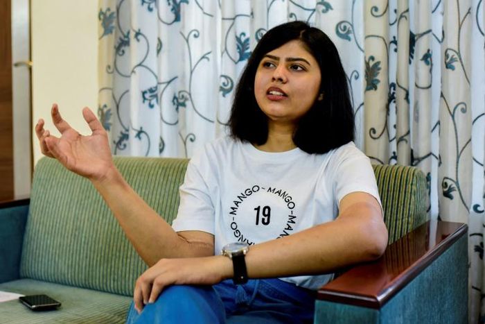 Shreya Siddanagowder gestures during an interview with AFP at her home in Pune, more than two years after she had both hands transplanted