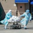 Bodies are moved to a refrigeration truck serving as a temporary morgue in New York, the main focus of the US outbreak, with more than 4,750 deaths