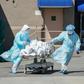 Bodies are moved to a refrigeration truck serving as a temporary morgue in New York, the main focus of the US outbreak, with more than 4,750 deaths