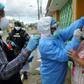 Health ministry personnel test a woman for the novel coronavirus in northern Guayaquil, Ecuador, on April 19, 2020