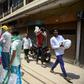People wait in line to collect free rations from a government store during India's nationwide lockdown