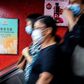 A government advertisement (L) promoting China’s national security law is displayed inside an MTR train station in Hong Kong