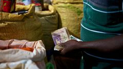 A trader attends to a customer (Photo: Abraham Ali)