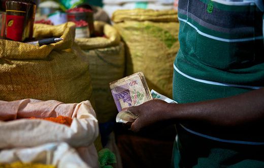 A trader attends to a customer (Photo: Abraham Ali)