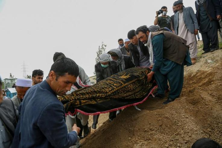 Mourners burying a victim of the militant attack on a Kabul hospital