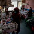 A nurse takes care of newborn babies rescued and brought to the Ataturk Children Hospital after their mothers were killed in an attack on a Kabul maternity hospital