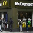 Delivery riders queue  outside a McDonald's in London; the company is facing a sexual harassment complaint filed at the OECD by an international coalition of labor unions