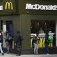 Delivery riders queue  outside a McDonald's in London; the company is facing a sexual harassment complaint filed at the OECD by an international coalition of labor unions