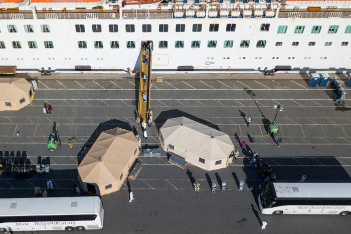 More passengers leave the Grand Princess cruise ship at the Port of Oakland in Oakland, California