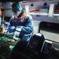 A French first aid worker from the Protection Civile Paris Seine holds an oxygen mask over the mouth and nose of a male patient suspected of being infected with COVID-19 a he lies in an ambulance