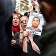 People march with signs calling for the release of detained Algerian opposition figure Karim Tabbou on January 24, 2020, during the 49th consecutive Friday demonstration against the Algerian government and the ruling class in Algiers