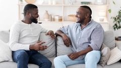 A photo of two men having a chat