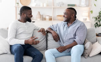 A photo of two men having a chat